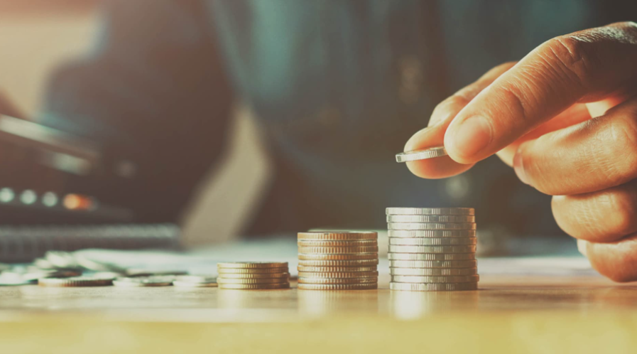 Fingers with coins for Why Your Money Just Sits There